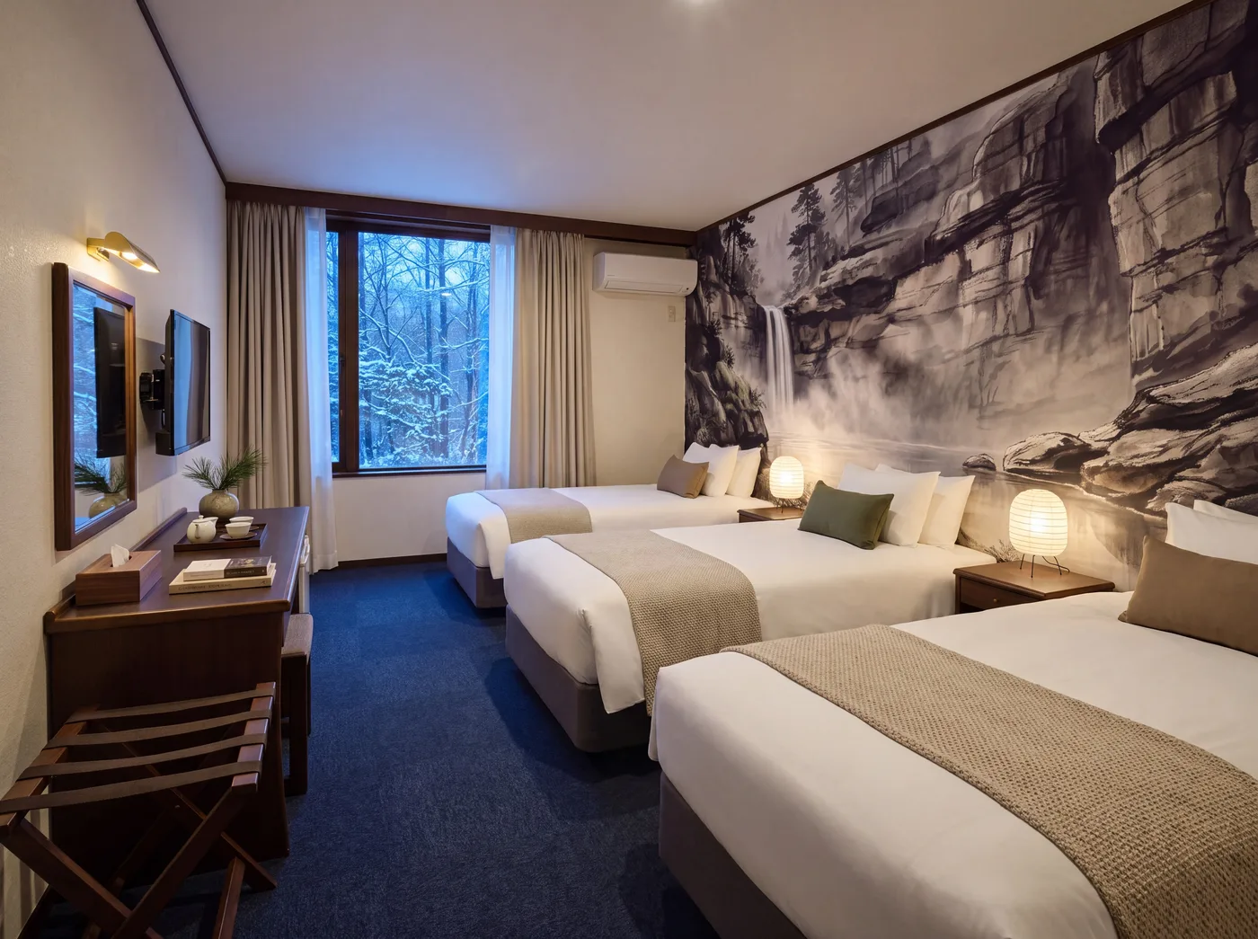 A lower-level room with a waterfall ink mural behind the beds